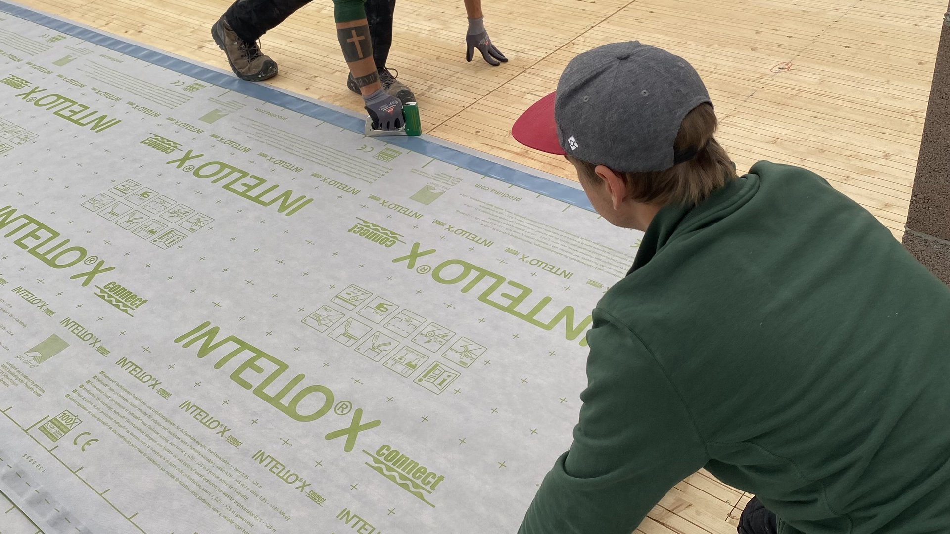 Bahn im Kehlbereich ausrollen und am Rand mit Tackerklammern fixieren